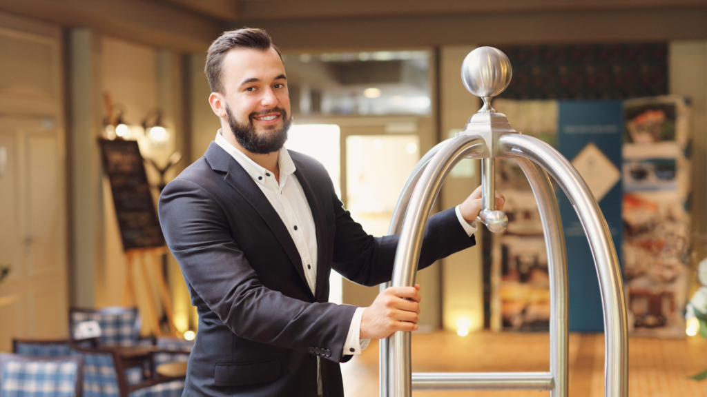 Hospitality worker pushing a bell cart after taking SuperHost.